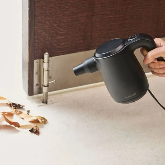 ドアの蝶番のホコリを吹き飛ばす様子